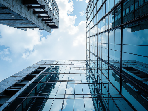 Luxury residential complex with modern glass architecture, multiple buildings with glass elements, upscale neighborhood setting